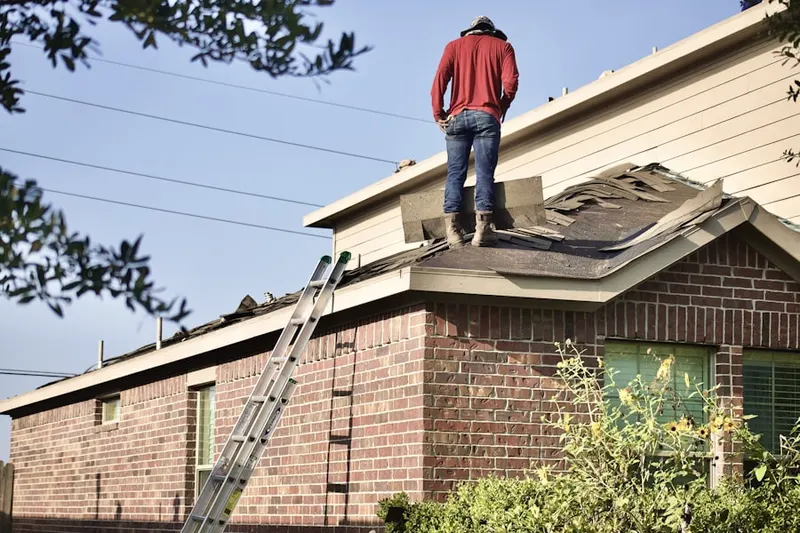 Professional roofer working on a residential roof in Franklin Field North